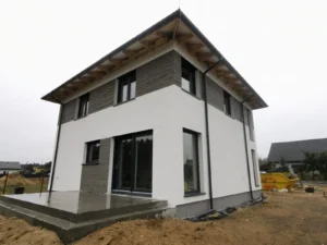 Firma budowlana Poznań - dom piętrowy z dachem kopertowym i garażem